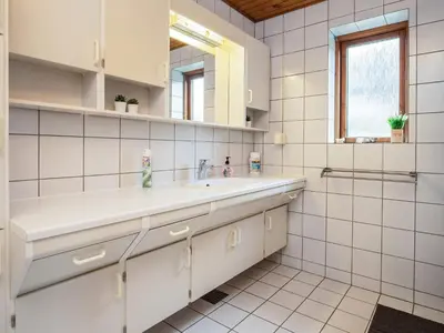a white bathroom with a sink and a mirror at 10 person holiday home in Karby-By Traum in Karby