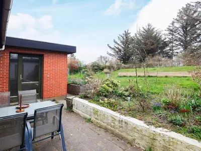 a patio with a table and chairs and a garden at 10 person holiday home in Karby-By Traum in Karby