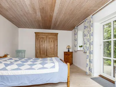 a bedroom with a bed and a wooden ceiling at 6 person holiday home in Thisted-By Traum in Thisted