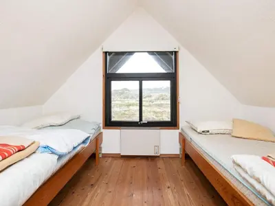 two beds in a room with a window at 6 person holiday home in Pandrup-By Traum in Pandrup