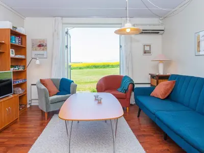 a living room with a couch and chairs and a table at 6 person holiday home in Lemvig-By Traum in Lemvig