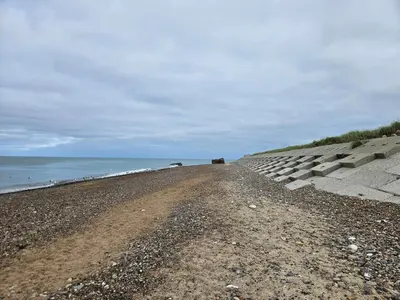 a dirt road next to the ocean on a beach at 7 person holiday home in Frøstrup in Frøstrup