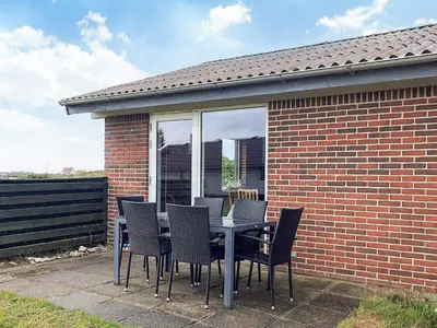 a table and chairs sitting on a patio at 7 person holiday home in Frøstrup in Frøstrup