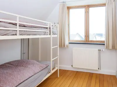 a bedroom with two bunk beds and a window at 8 person holiday home in Thyborøn-By Traum in Thyborøn