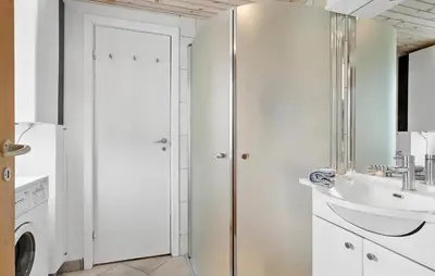 a white bathroom with a sink and a refrigerator at Cozy Home In Vestervig With Sauna in Vestervig