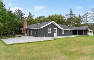 a black house with a large yard at Cozy Home In Vestervig With Sauna in Vestervig