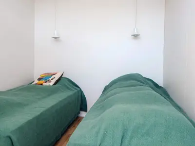 two beds sitting next to each other in a bedroom at 4 person holiday home in Blokhus-By Traum in Blokhus