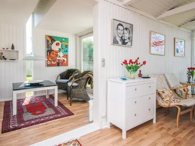 a living room with a table and a couch at 4 person holiday home in Blokhus-By Traum in Blokhus