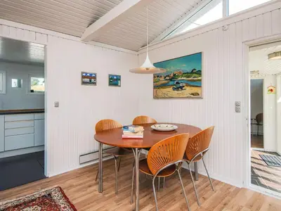 a dining room with a wooden table and chairs at 4 person holiday home in Blokhus-By Traum in Blokhus