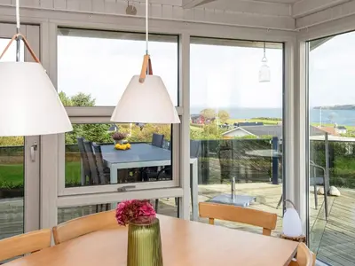 a dining room with a view of the ocean at 8 person holiday home in Lemvig-By Traum in Lemvig