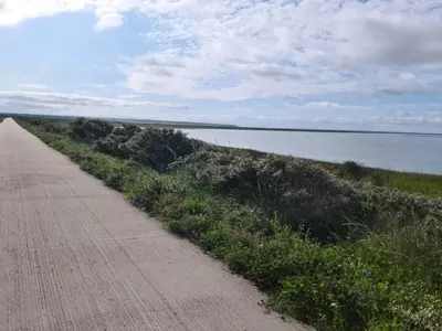 a dirt road next to a body of water at 7 person holiday home in Vestervig-By Traum in Vestervig