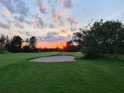 a sunset on a golf course with a pond at 6 person holiday home in Fjerritslev in Fjerritslev
