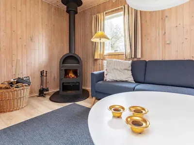 a living room with a couch and a fireplace at 6 person holiday home in Fjerritslev in Fjerritslev