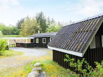 a black house with a slate roof at 6 person holiday home in Fjerritslev in Fjerritslev
