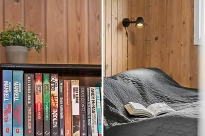 a book shelf with books on it next to a bed at 813-Harboore-Neerlandiavej-136 in Harboør