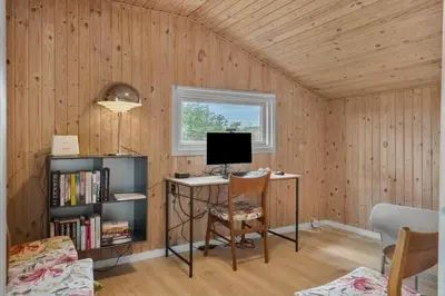 a room with a desk with a computer and a window at 813-Harboore-Neerlandiavej-136 in Harboør