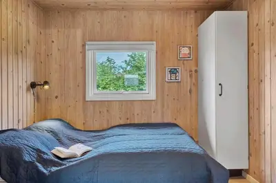 a bedroom with a bed and a window at 813-Harboore-Neerlandiavej-136 in Harboør