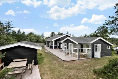 a row of black modular homes with a deck at BL1107-Blokhus-Soren-Petersvej-16 in Blokhus