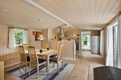 a kitchen and dining room with a table and chairs at BL1107-Blokhus-Soren-Petersvej-16 in Blokhus