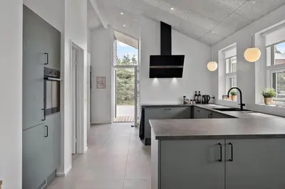 a large kitchen with white walls and a large island at BL1118-Saltum-Vesterhavs-Sletten-37 in Saltum