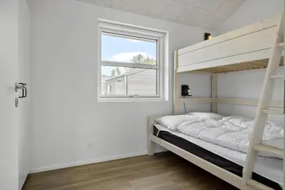a bedroom with a bunk bed and a window at BL1118-Saltum-Vesterhavs-Sletten-37 in Saltum