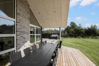 a porch of a house with a wooden deck at BL1118-Saltum-Vesterhavs-Sletten-37 in Saltum