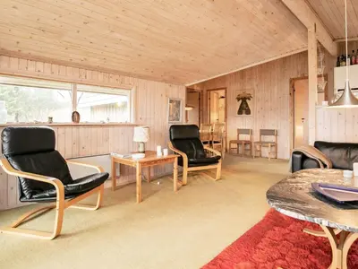 a living room with two chairs and a table at Spacious Retreat with Views - By Traum Ferienwohnungen in Blokhus