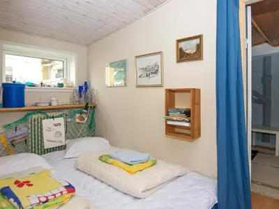 a small bedroom with a bed and a window at 5 person holiday home in Thyborøn in Thyborøn