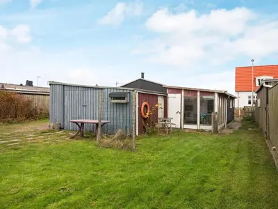 a backyard with a shed and a picnic table at 5 person holiday home in Thyborøn in Thyborøn