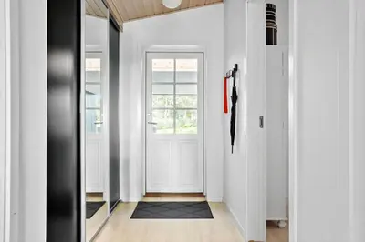 a hallway with a white door and a window at LF14198-Roslev-Bagvejen-2 in Roslev