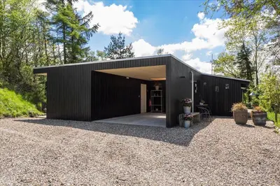 a black house with a black exterior at LF14198-Roslev-Bagvejen-2 in Roslev