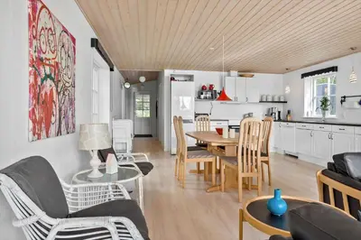a living room and kitchen with a table and chairs at LF14198-Roslev-Bagvejen-2 in Roslev