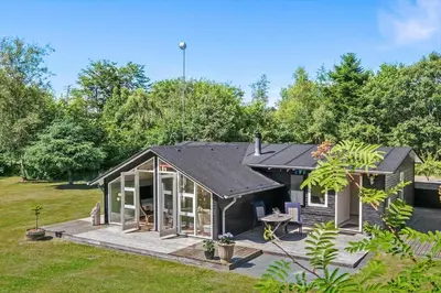 a small house with a deck in a yard at LF15033-Skals-Lynderupvej-33-A in Skals