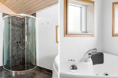 a bathroom with a shower and a tub and a sink at LF14194-Roslev-Bagvejen-26 in Roslev