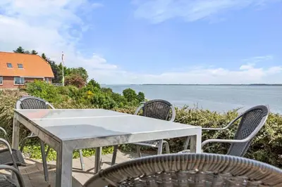 a table and chairs with a view of the water at LF14194-Roslev-Bagvejen-26 in Roslev