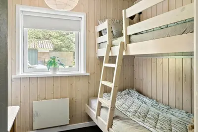 a bunk bed in a room with a ladder and a window at LF11109-Struer-Barsidalvej-9 in Struer