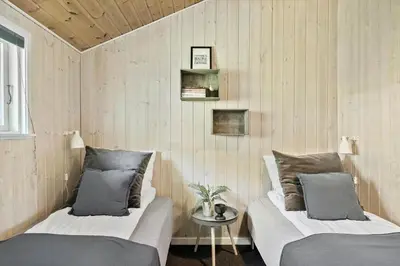 a bedroom with two beds and a table with a plant at LF11109-Struer-Barsidalvej-9 in Struer