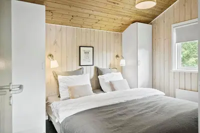 a bedroom with a large bed with white sheets and pillows at LF11109-Struer-Barsidalvej-9 in Struer