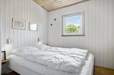 a white bed in a room with a window at LF101-Vestervig-Hellesvej-1 in Vestervig