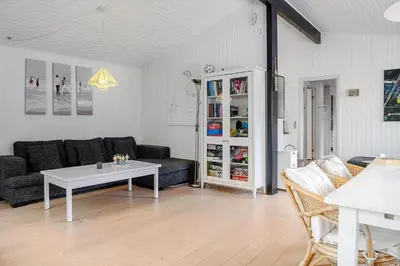 a living room with a couch and a table at LF10236-Thyholm-Svinget-18 in Thyholm