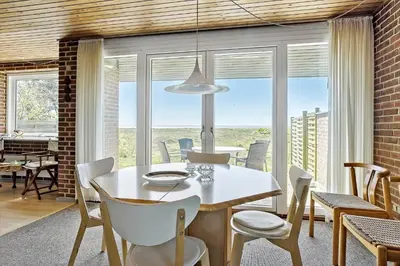 a dining room with a white table and chairs at LF10314-Hurup-Thy-Edderfuglevej-15 in Sindrup