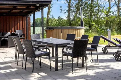 a table and chairs on a patio with a grill at LF14145-Spottrup-Uglkaeret-5 in Spottrup