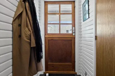 a wooden door in a room with a window at LF14163-Roslev-Kybehuse-3 in Roslev