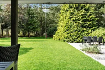 a patio with chairs and a grass yard at LF14163-Roslev-Kybehuse-3 in Roslev