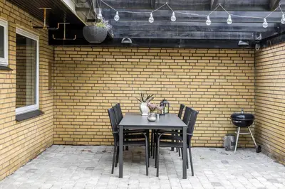 a table and chairs in front of a brick wall at LF14127-Roslev-Kybehuse-127 in Roslev