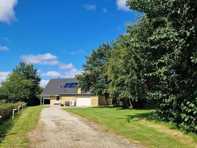a house with a gravel road in front of it at LF14127-Roslev-Kybehuse-127 in Roslev