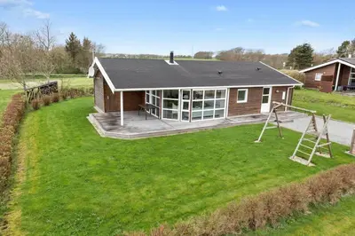 a house with a large yard with a playground at LF626-Snedsted-Kongens-Borer-4 in Snedsted