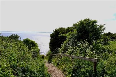 a bench on the side of a trail near the water at LF112-Vestervig-Ingeborgs-Alle-12 in Vestervig
