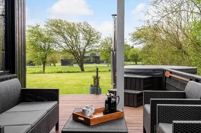 a patio with chairs and a table and a grill at LF112-Vestervig-Ingeborgs-Alle-12 in Vestervig