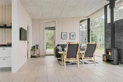 a living room with two chairs and a fireplace at LF14137-Spottrup-Fjordvej-39 in Spottrup